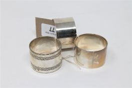 A pair of silver napkin rings together with one other (3)