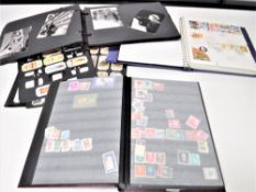 A box containing small vintage leather case, cigarette cards, stamp albums,