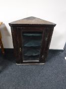 An antique oak glazed door hanging corner cupboard