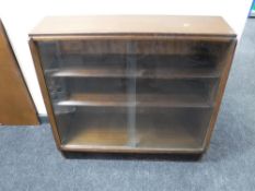 A mid twentieth century teak sliding glass door bookcase