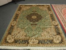 A Keshan carpet on green ground 280 cm x 200 cm