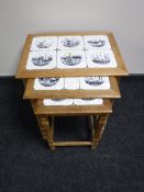 A nest of three oak tiled top tables together with a mahogany wine table