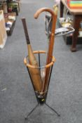 A mid twentieth century stick stand with two sticks and shooting stick,