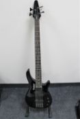 An Rebel 4K electric bass guitar on stand