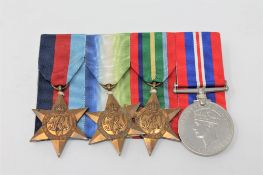A group of George VI war medals with ribbons on bar