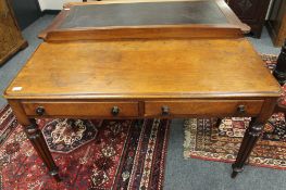 An early Victorian mahogany writing table on reeded legs,