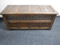 A carved oak blanket box