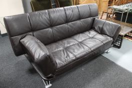 A contemporary brown leather folding bed settee
