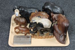 A tray of seven carved hardwood animal ornaments together with a plated cigarette case