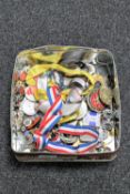 A tin of enamelled badges,
