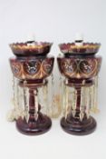 Two Victorian converted red glass lustre's with drops,