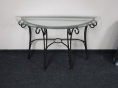 A d-shaped glass and metal hall table