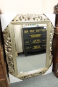 An ornate silvered framed mirror, 94 cm x 123 cm.