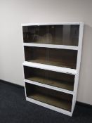 A four tier painted stacking bookcase