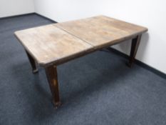 A Victorian oak dining table with leaf