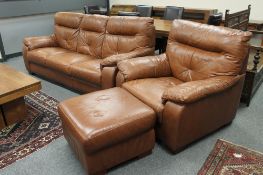 A brown leather three seater settee with matching armchair and footstool.