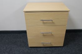A contemporary three drawer chest in a beech finish