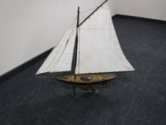 A wooden pond yacht on stand