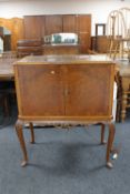 A figured walnut double door cocktail cabinet on cabriole legs CONDITION REPORT: