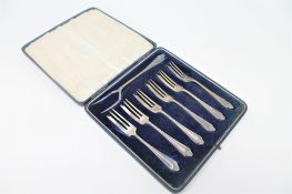 A set of six cased silver dessert forks with silver prong