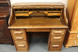An early twentieth century oak roll topped desk,