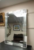 A frameless two tone sectional mirror, 70 cm x 101 cm.