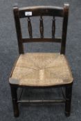 An early twentieth century oak child's rush seated chair