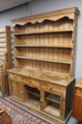 An early 20th century pine farmhouse kitchen dresser