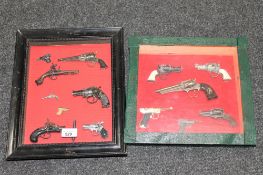 Two display frames containing a collection of miniature replica pistols
