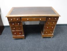 A Victorian mahogany twin pedestal writing desk with inset brown leather panel
