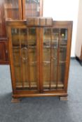 An early twentieth century oak double door bookcase