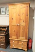 A pine double door wardrobe fitted with three drawers width 91 cm.