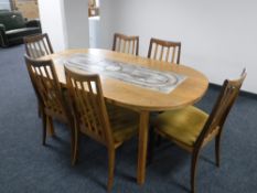 A mid twentieth century teak tiled topped pull out dining table with leaf together with six G-plan