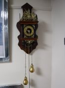 A reproduction continental weight driven wall clock with brass weights