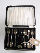A set of six cased sterling silver teaspoons with sugar tongs retailed by James Walker & Co of
