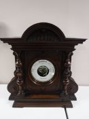 A Victorian aneroid barometer in carved mahogany case.