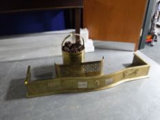 An early 20th century brass fire curb,