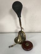 An antique brass car horn together with a Rabone leather tape measure
