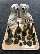 A pair of Staffordshire dogs together with a collection of brass bells