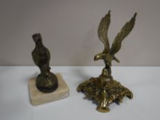 A brass figure of a pheasant mounted on a marble base together with a brass figure of an eagle