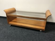 A teak G Plan glass topped coffee table on wheels