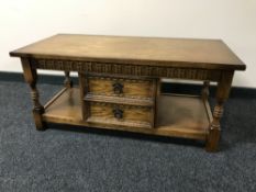 An oak two tier coffee table fitted two drawers