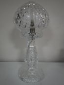 A cut crystal table lamp with shade
