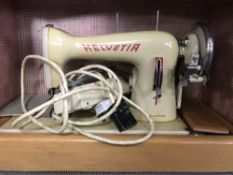 A cased mid twentieth century Helvetia electric sewing machine