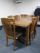 A Julian Bowen contemporary extending dining table together with six rail backed chairs