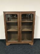 An oak double door glazed bookcase