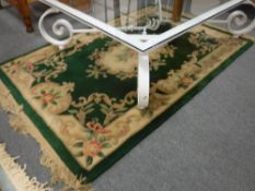A green fringed embossed Chinese rug
