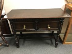 An oak two drawer hall table,