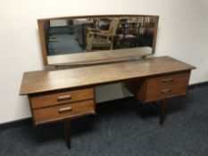 A teak G Plan knee hole dressing table with stool and matching four drawer chest