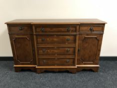 An inlaid yew wood break-front sideboard